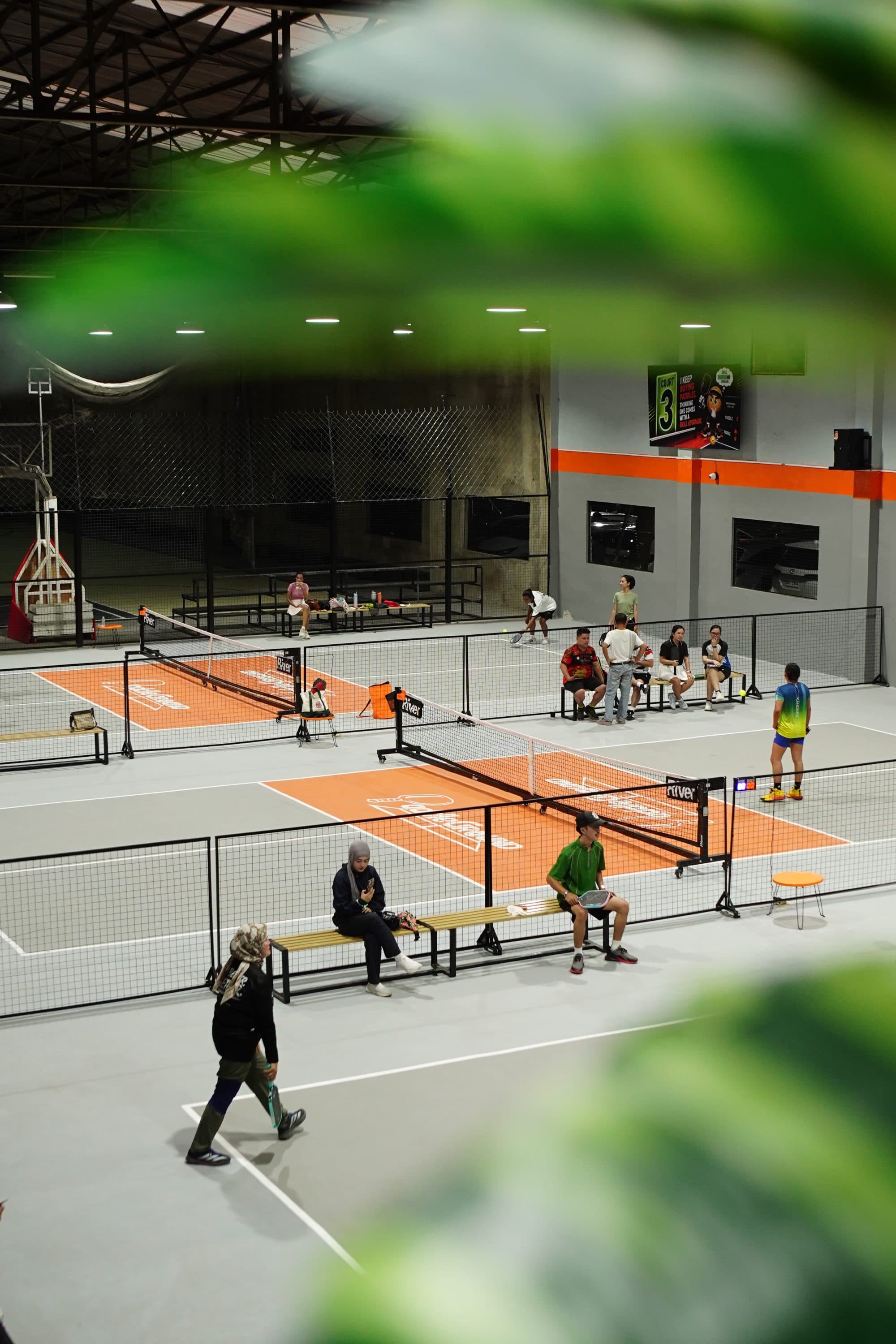 Paddle Ground courts seen through the lounge greenery
